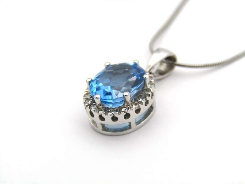 9K gold blue topaz and diamond pendant.
