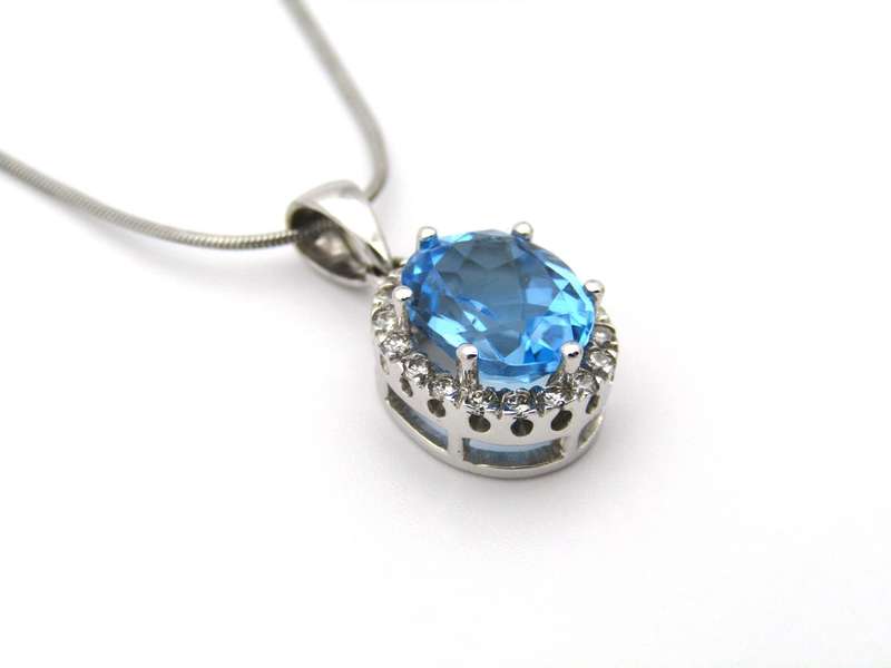 9K gold blue topaz and diamond pendant.