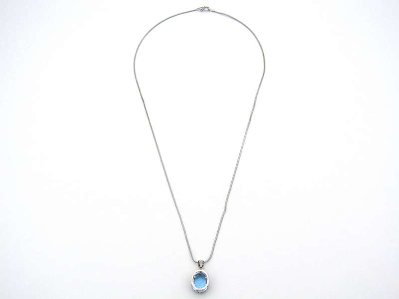 9K gold blue topaz and diamond pendant.