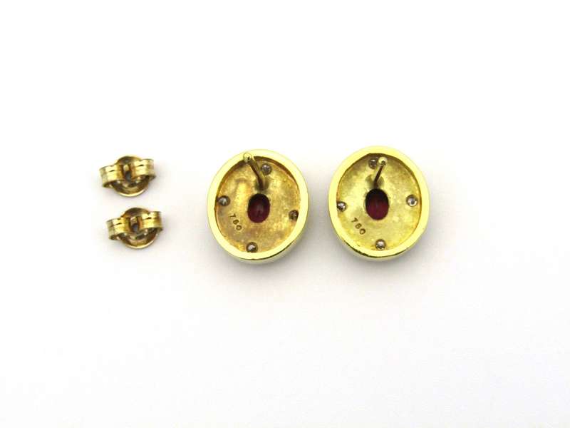 A pair of 18K gold ruby and diamond earrings.