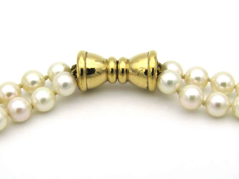 Double strand of pearls with gold plated magnetic clasp.