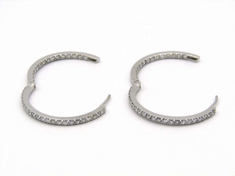 18K gold diamond hoop earrings.