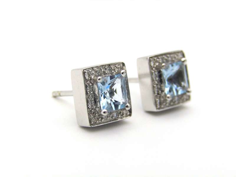A pair of 18K gold Blue Topaz and diamond earrings.