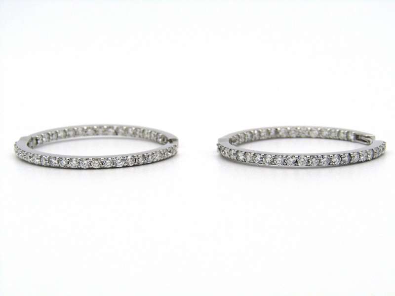 18K gold diamond hoop earrings.