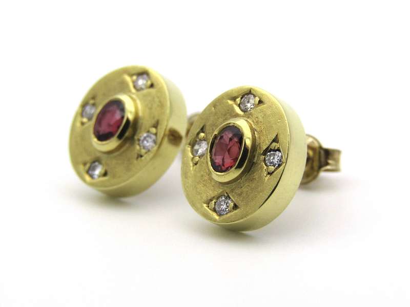 A pair of 18K gold ruby and diamond earrings.