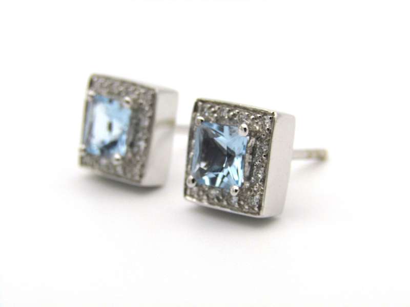 A pair of 18K gold Blue Topaz and diamond earrings.