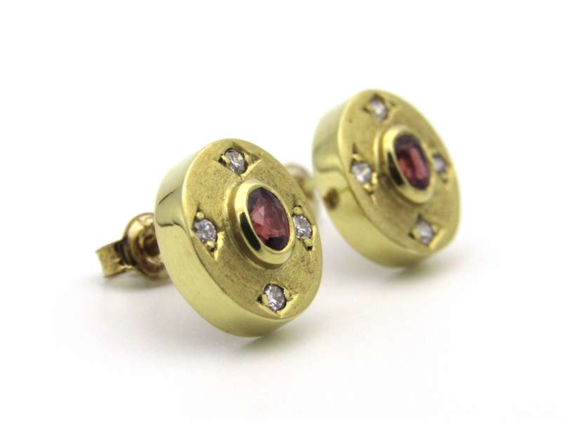 A pair of 18K gold ruby and diamond earrings.