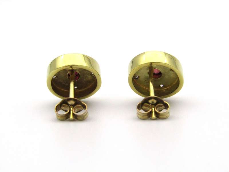 A pair of 18K gold ruby and diamond earrings.