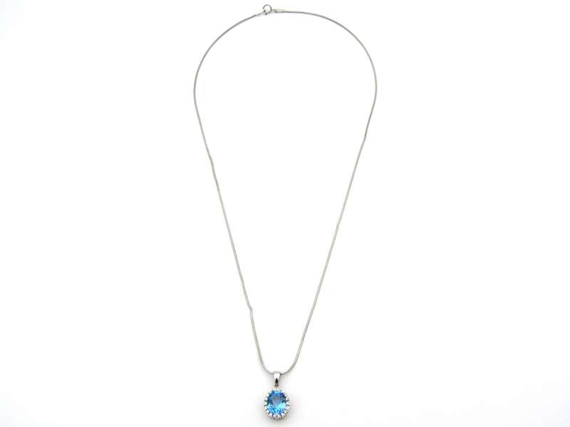 9K gold blue topaz and diamond pendant.