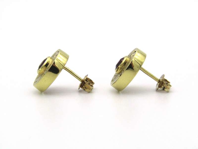 A pair of 18K gold ruby and diamond earrings.
