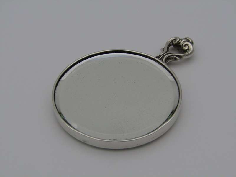 A sterling silver hand mirror by Cartier. Circa 1920s.