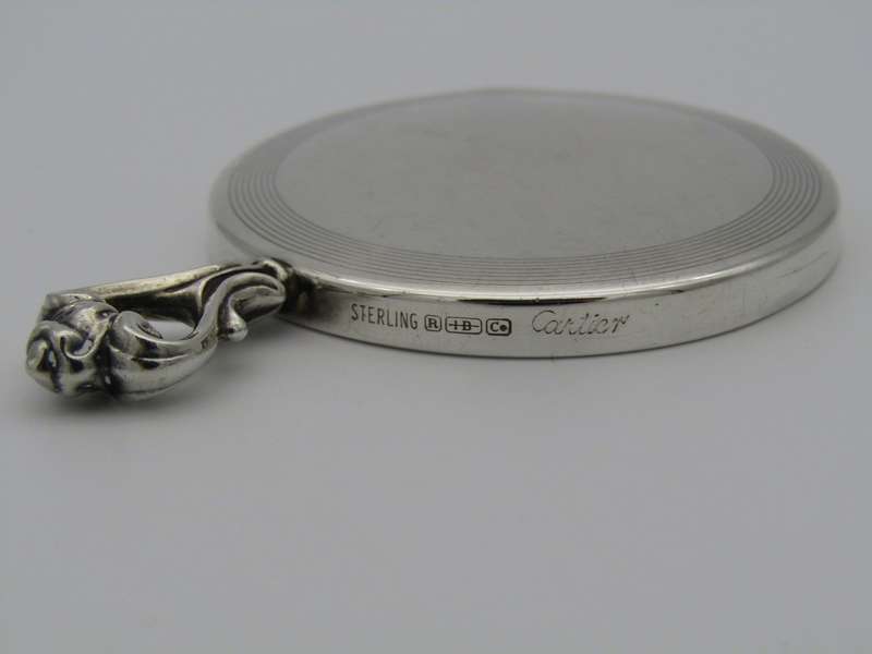 A sterling silver hand mirror by Cartier. Circa 1920s.