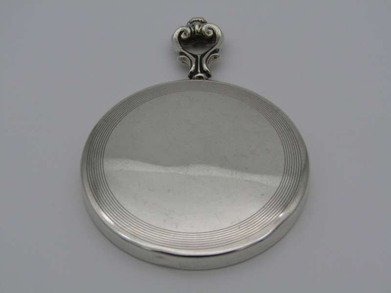 A sterling silver hand mirror by Cartier. Circa 1920s.