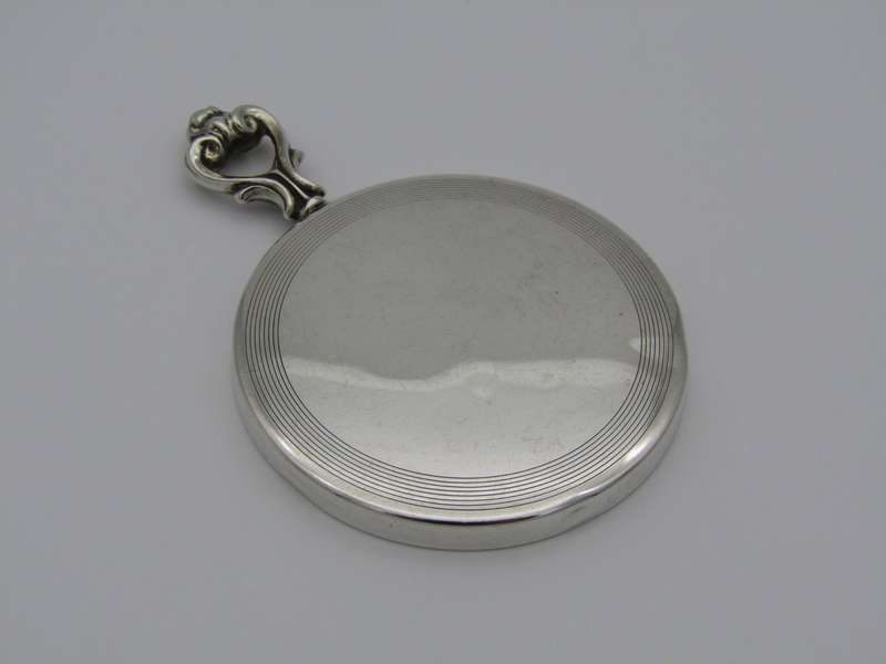 A sterling silver hand mirror by Cartier. Circa 1920s.