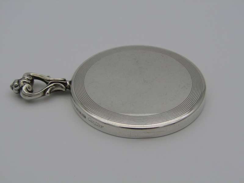 A sterling silver hand mirror by Cartier. Circa 1920s.
