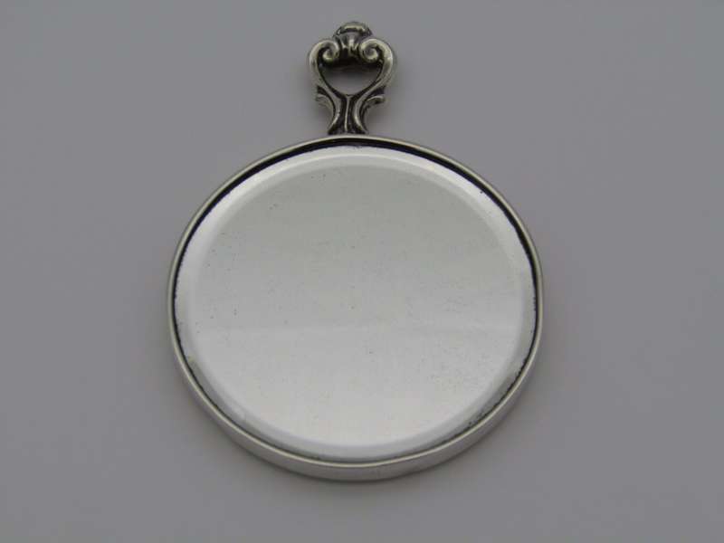 A sterling silver hand mirror by Cartier. Circa 1920s.