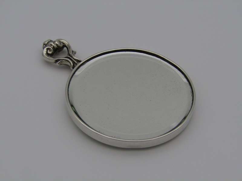 A sterling silver hand mirror by Cartier. Circa 1920s.