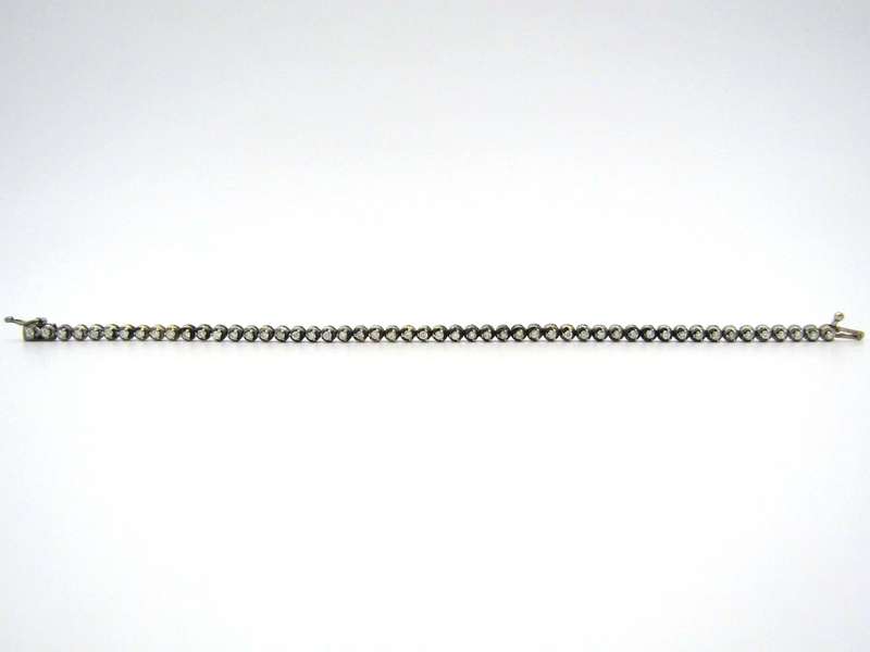 14K gold diamond tennis bracelet.