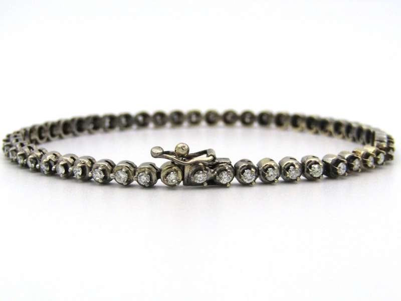 14K gold diamond tennis bracelet.
