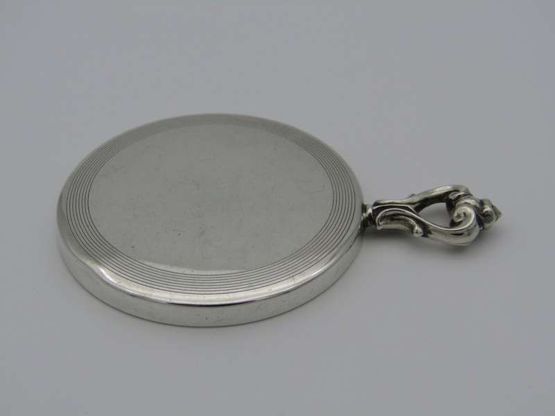 A sterling silver hand mirror by Cartier. Circa 1920s.