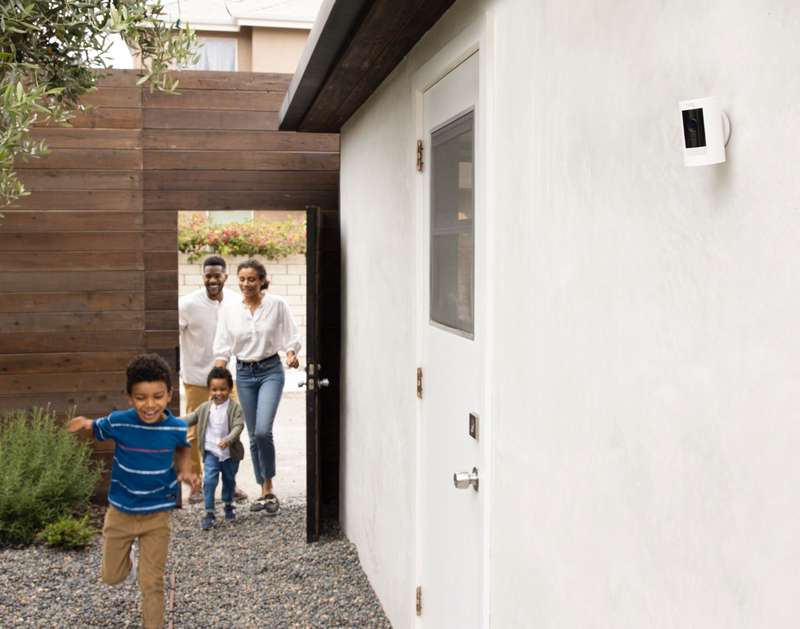 Family running outside their home.