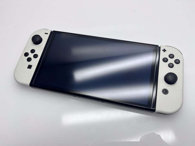 Nintendo Switch OLED 64GB Black + 1 Joy-Con Grip + HDMI &amp; Power Cable + Carry Case + 4 Games