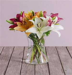 Lush Lilies In A Clear Vase