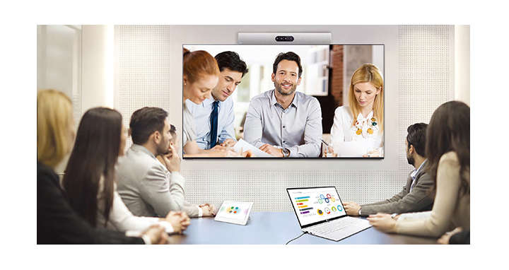 A video conference is being held as people are screened on signage installed on the wall.