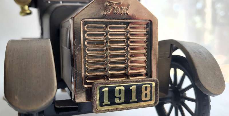 A Vintage 1970's, (1918 Model T Ford - Whisky Decanter) with a working musical box & shot glasses