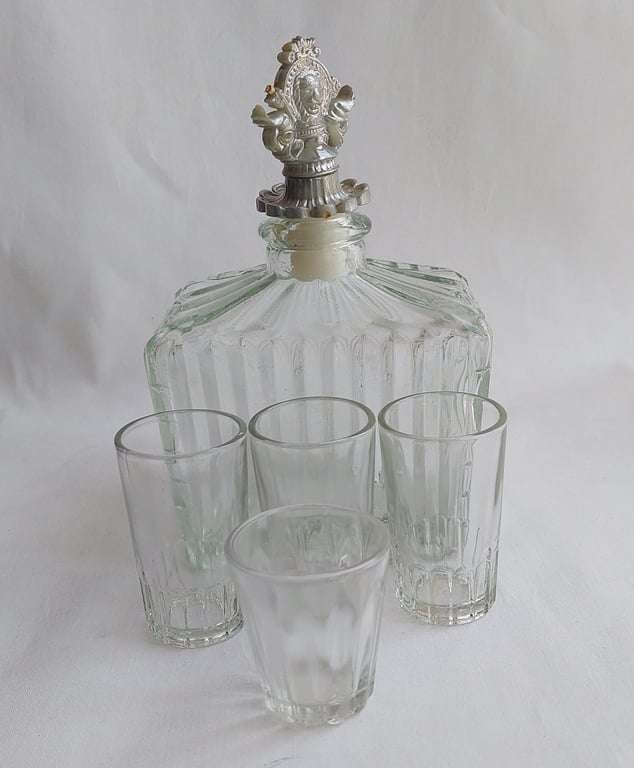 A Vintage 1970's, (1918 Model T Ford - Whisky Decanter) with a working musical box & shot glasses