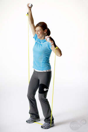 Woman doing a side stretch with Wii Remote/nunchuck and resistance band in EA Sports Active: More Workouts