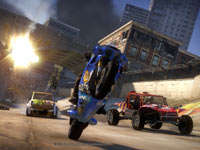 A superbike popping a wheelie to pull ahead and avoid an exploding bridge in Motorstorm Apocalypse