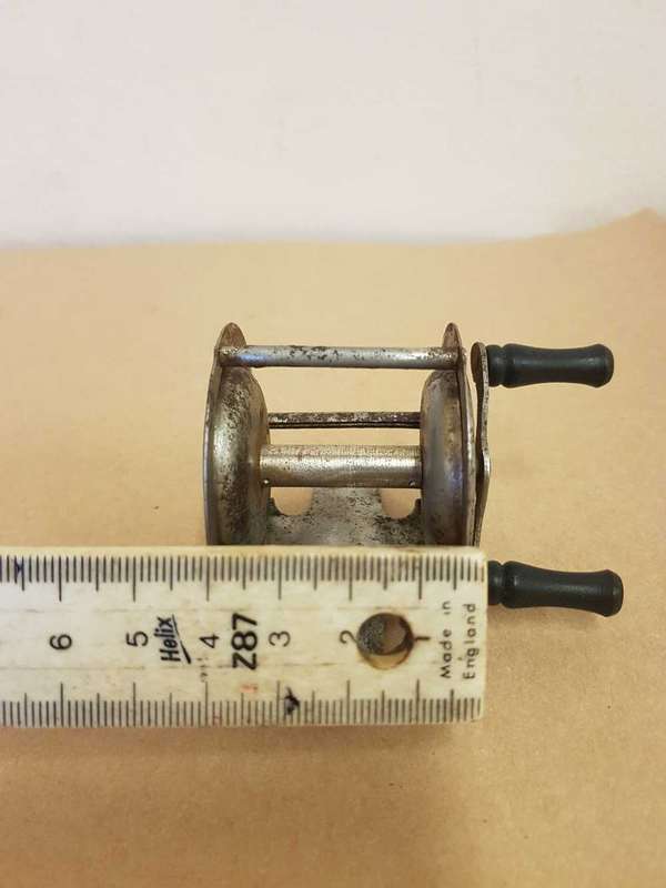 Vintage toy fishing reel.
