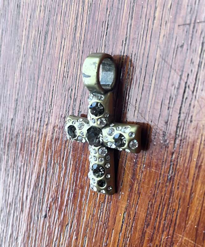 Metal cross pendant with decorative stones