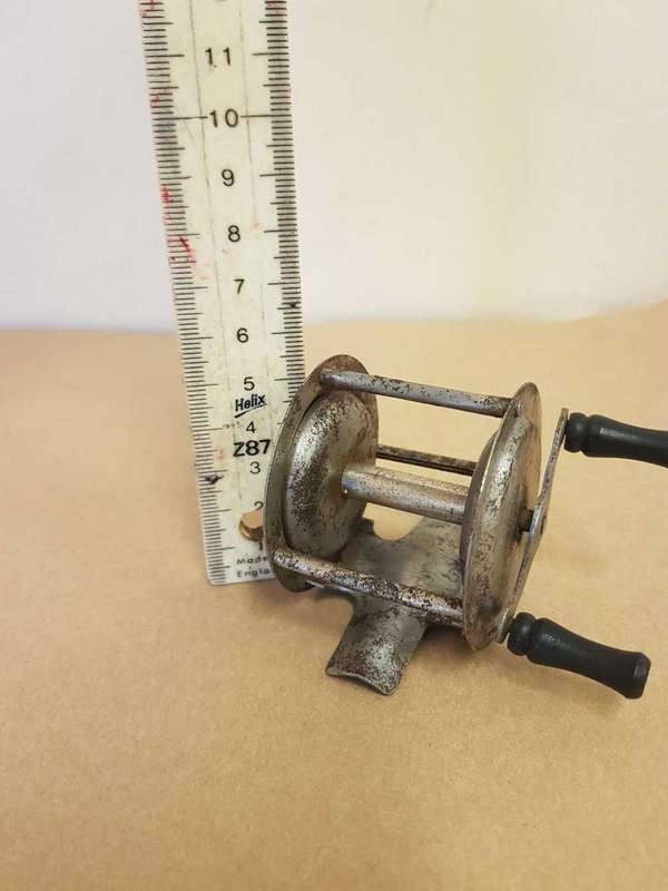 Vintage toy fishing reel.