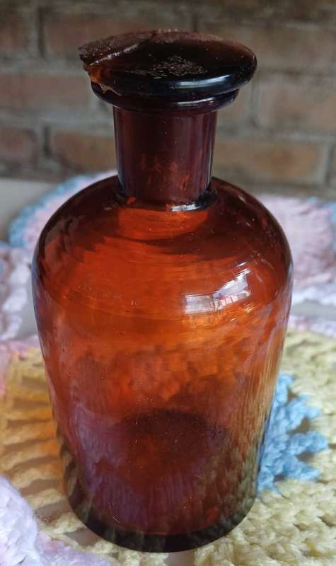 Vintage amber glass bottle with glass stopper