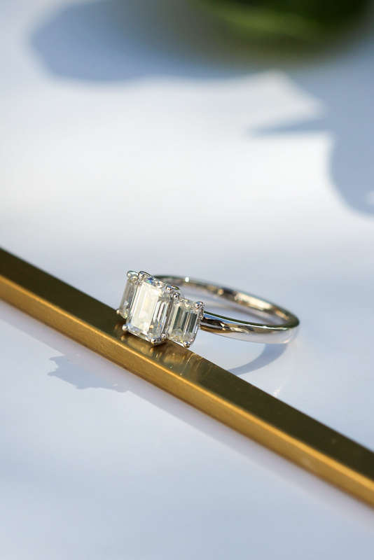 1ct Emerald Cut Moissanite Trilogy Ring in Platinum