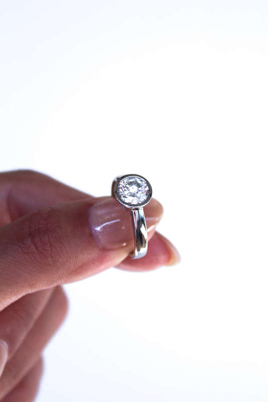 The Platinum Bezel Moissanite Ring