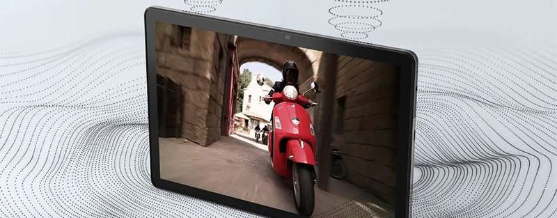 Tab M10 Gen 3 front facing left with person driving a motor scooter on the screen, and illustrating how Dolby AtmosÂ® emits soundwaves in a 360-degrees.