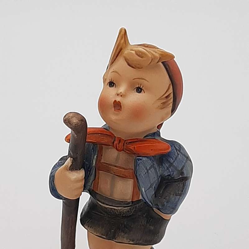 Boy Holding Walking Stick With Orange Bow Around Neck Hummel Figurine