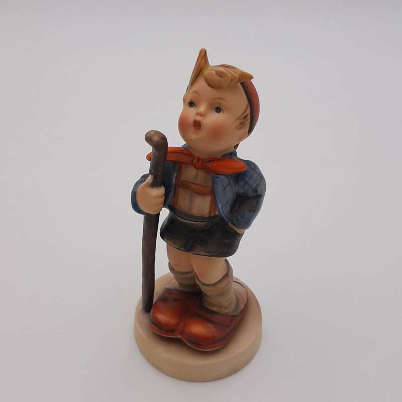 Boy Holding Walking Stick With Orange Bow Around Neck Hummel Figurine