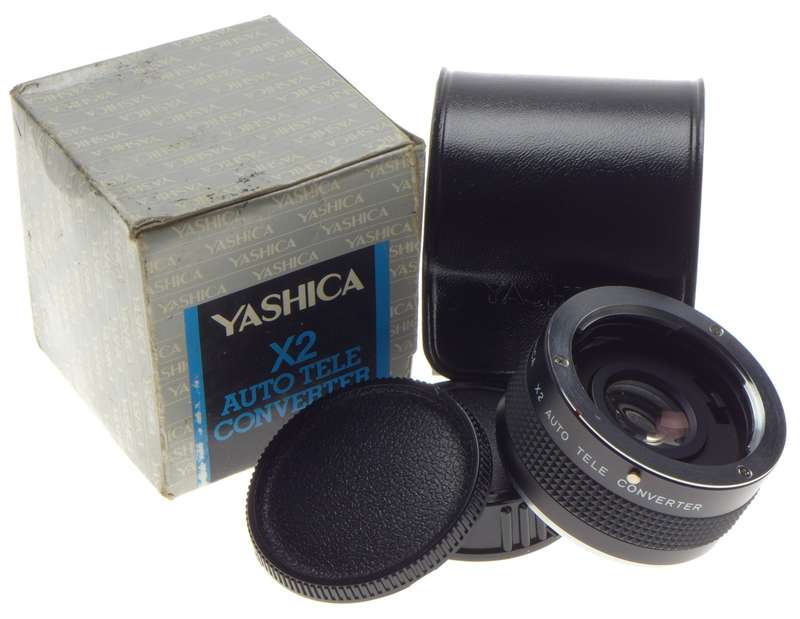 Yashica x 2 Auto Tele Converter Mint in box with caps. Perfectly clean glass.