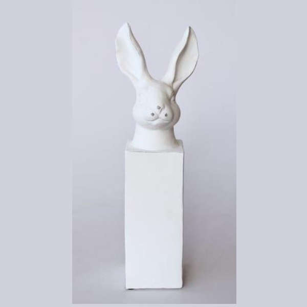 Tall white bunny head on column