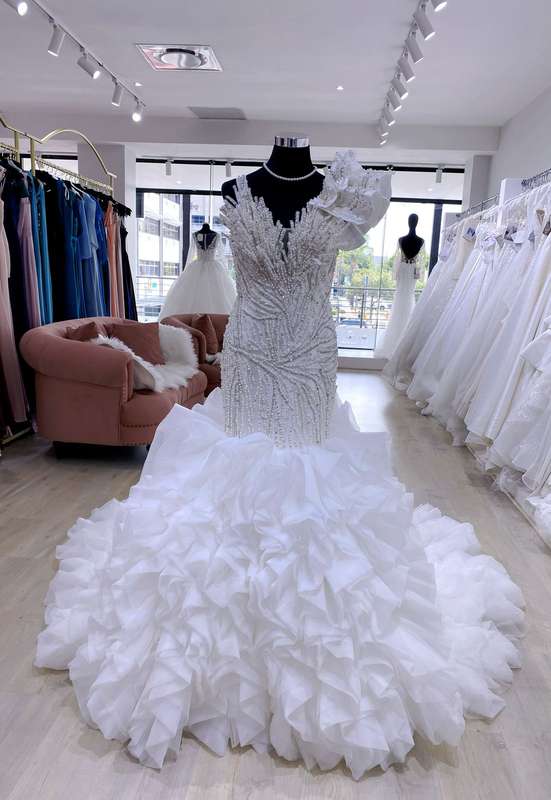 Anastacia , Mermaid wedding dress with pearl detail and ruffled trail.
