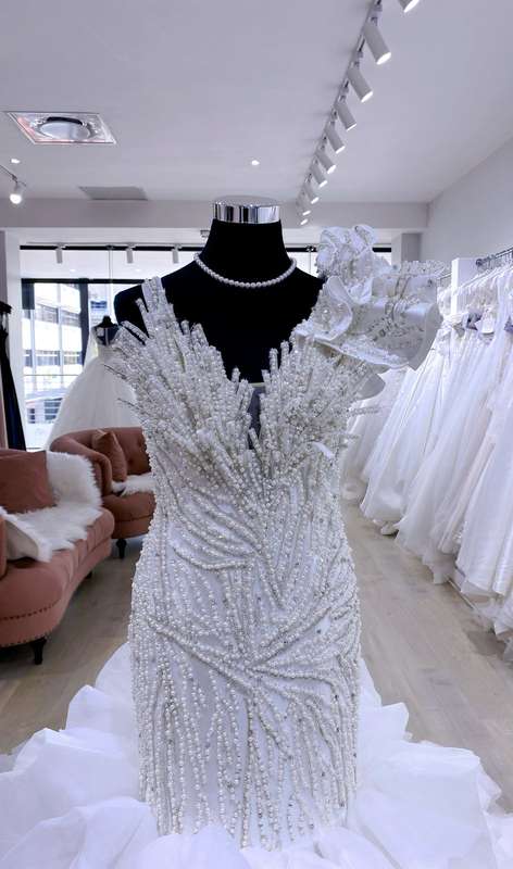 Anastacia , Mermaid wedding dress with pearl detail and ruffled trail.