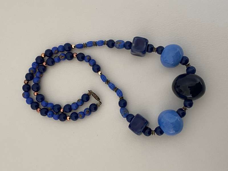 Necklace with Glass beads - Large blue round beads in the front with smaller blue beads in betwee...