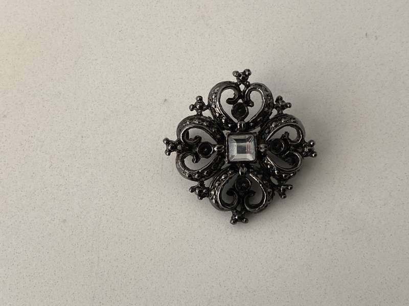 Brooch - Black Colour Square With Heart Shapes. Has A White Bead in Centre #ML681