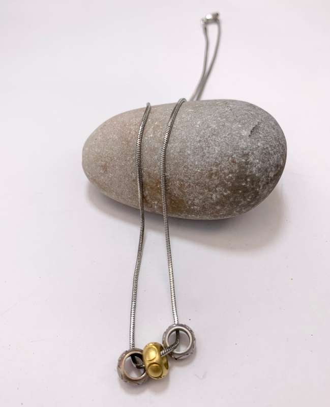 Pendant - Friendship Rings On Chain. Bronze, Gold and Silver Colour Rings On Decorative Silver Co...