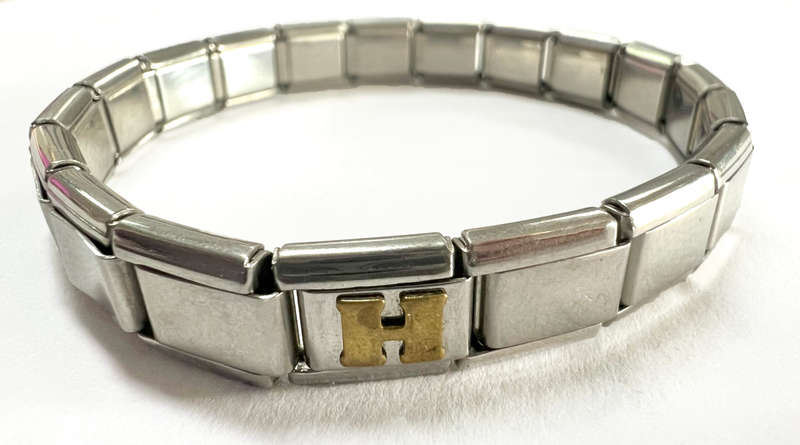 Bracelet - Stainless Steel Nomination Bracelet. One Gold Coloured H Link. (20 Links in total) ML1798