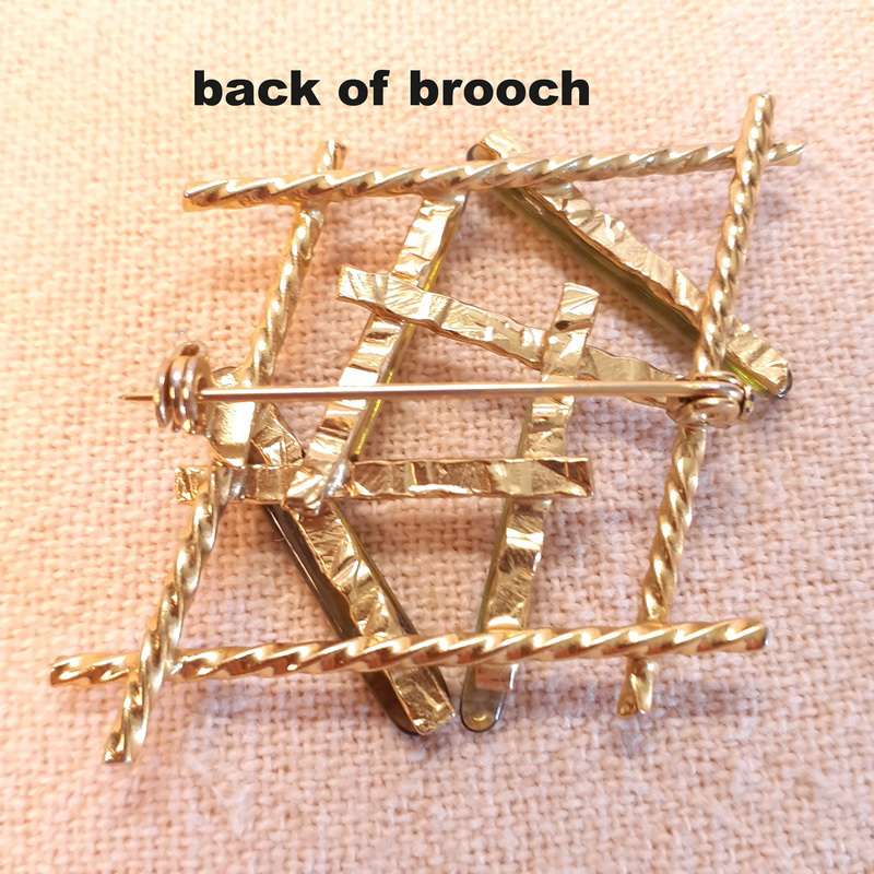Vintage gold brooch with pale green stones/glass